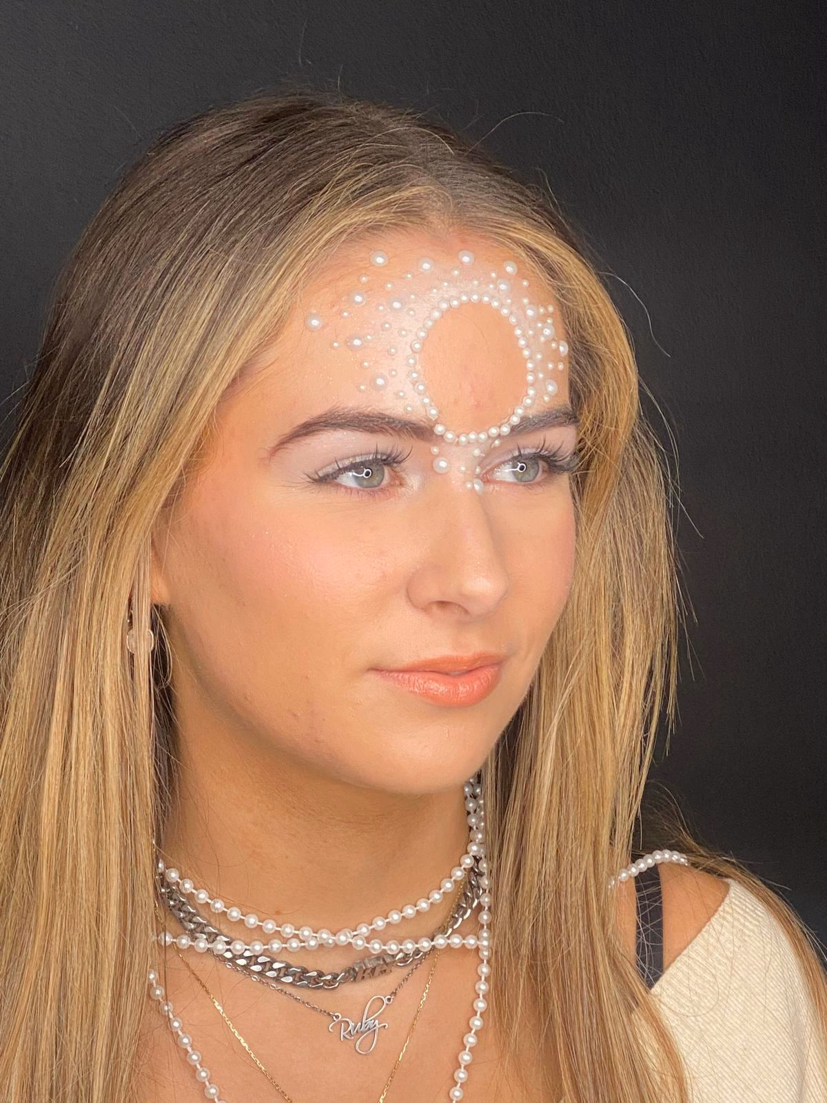 A bride having her makeup applied on the morning of her wedding